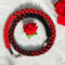 Crimson Noir Kumihimo necklace by Bead & Braid Collective, red and black spiral beadwork styled with a red rose accent